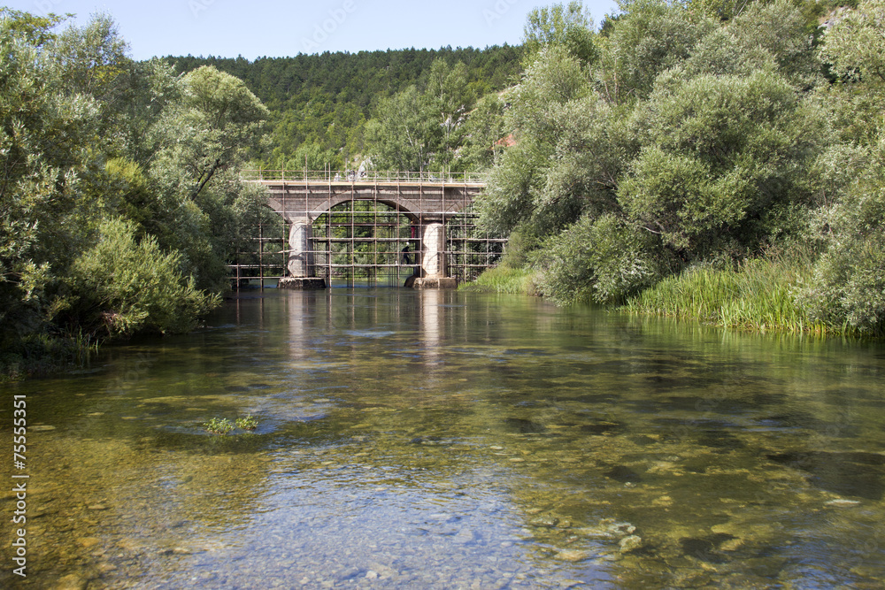 Renovation of ancient stone arch bridge over river Cetina