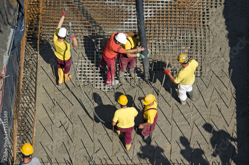 Construction workers casting foundations of hydro power plant