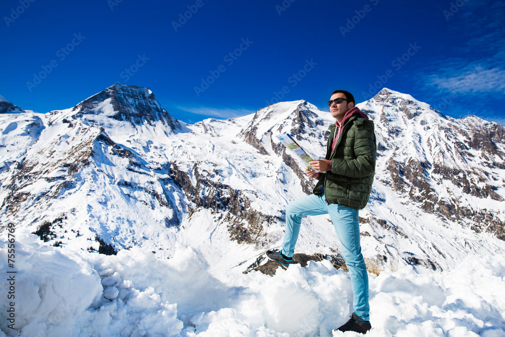 Tourist on the background of snowy mountains