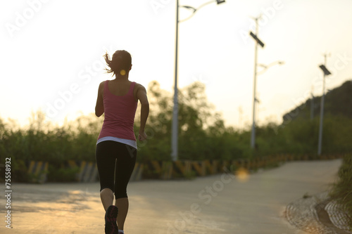 woman runner running on mountain trail