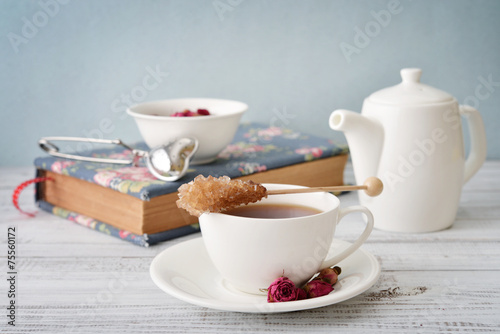 Cup of tea with dry rose buds