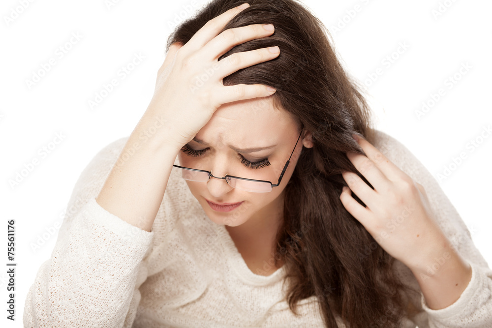 depressed young woman resting on her hand depressed young woman resting on her hand