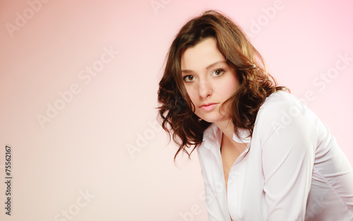 Portrait of sexy brunette girl long hair on pink