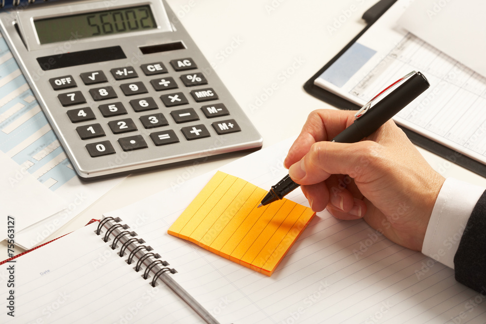 Businesswoman working with calculator Businesswoman working with calculator