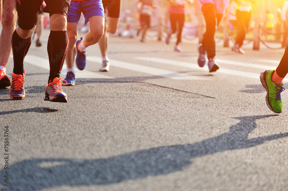 	marathon athletes legs running on city road
