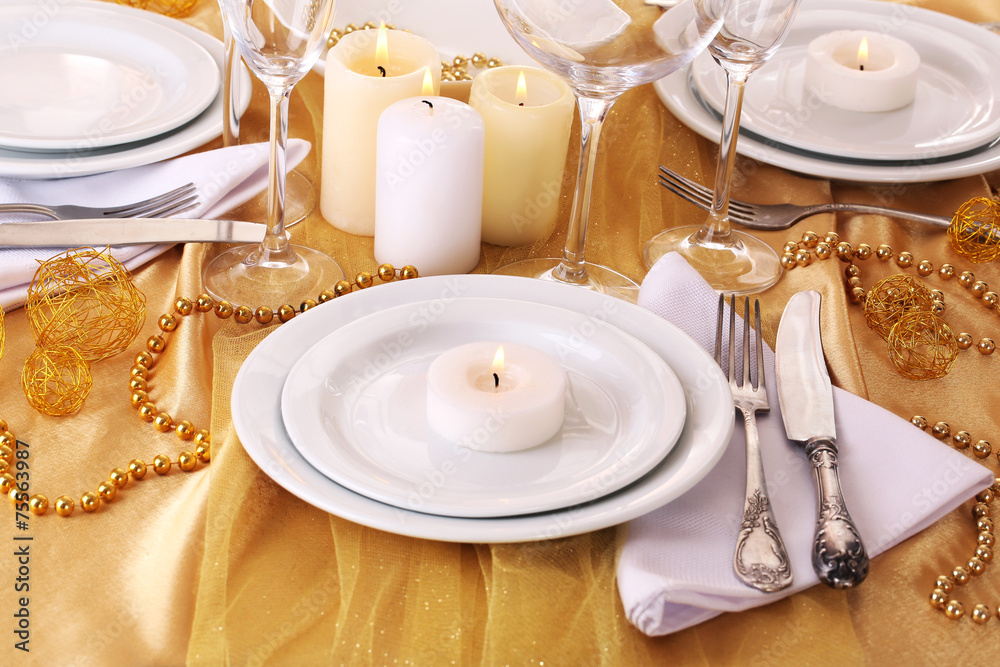 Beautiful holiday table setting in white and gold color Beautiful holiday table setting in white and gold color