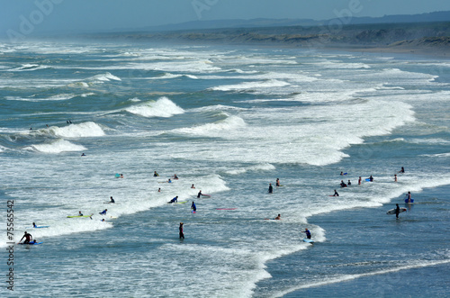 Surfing in Muriwai beach - New Zealand