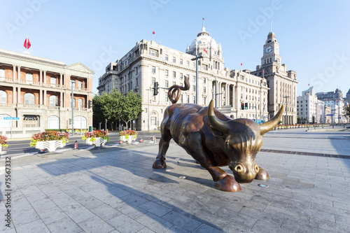 Photography Copper Bull statue on the modern city  street of shanghai.