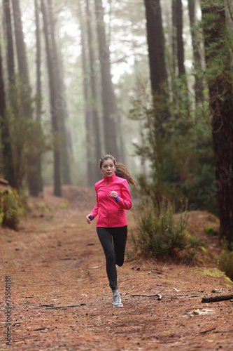 Running woman in forest woods training