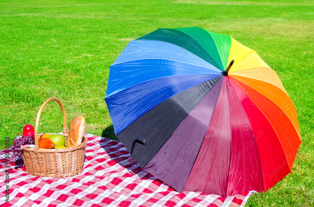 Rainbow umbrella and Picnic basket Stock Photo | Adobe Stock