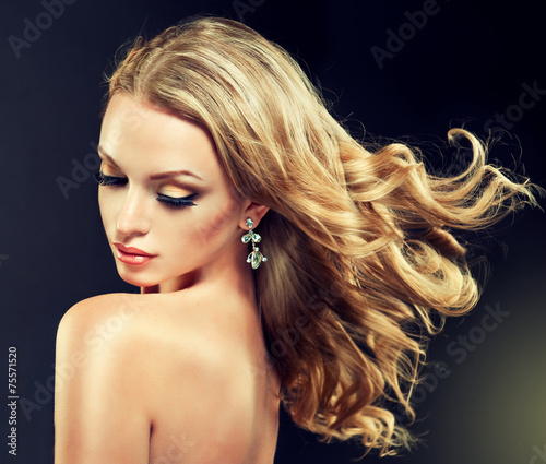 Beautiful model blond with curly hair and fashion earings