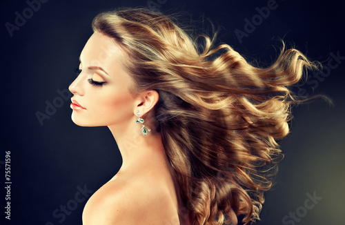 Beautiful model blond with curly hair and fashion earings