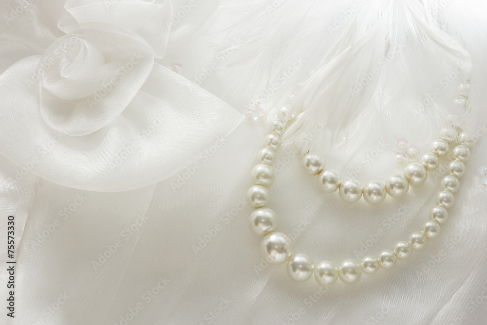 Pearl necklace on lace background.