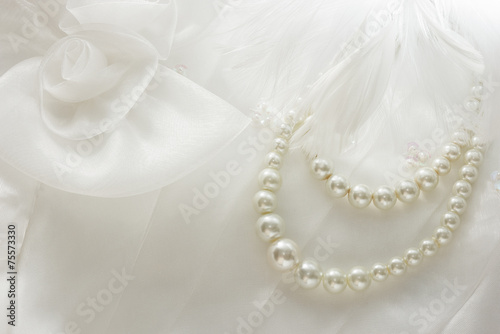 Pearl necklace on lace background.