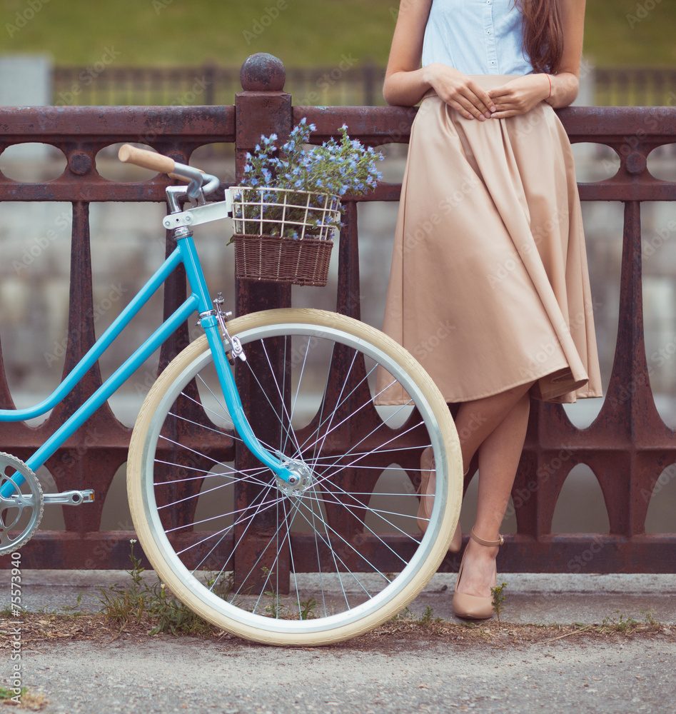 Young beautiful, elegantly dressed woman with bicycle - obrazy, fototapety, plakaty 