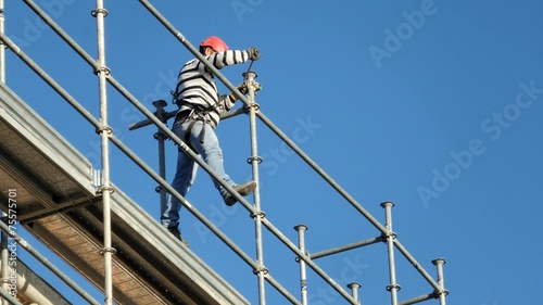 Construction worker on scaffolding photo