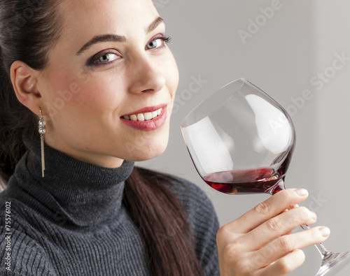 portrait of young woman with a glass of red wine