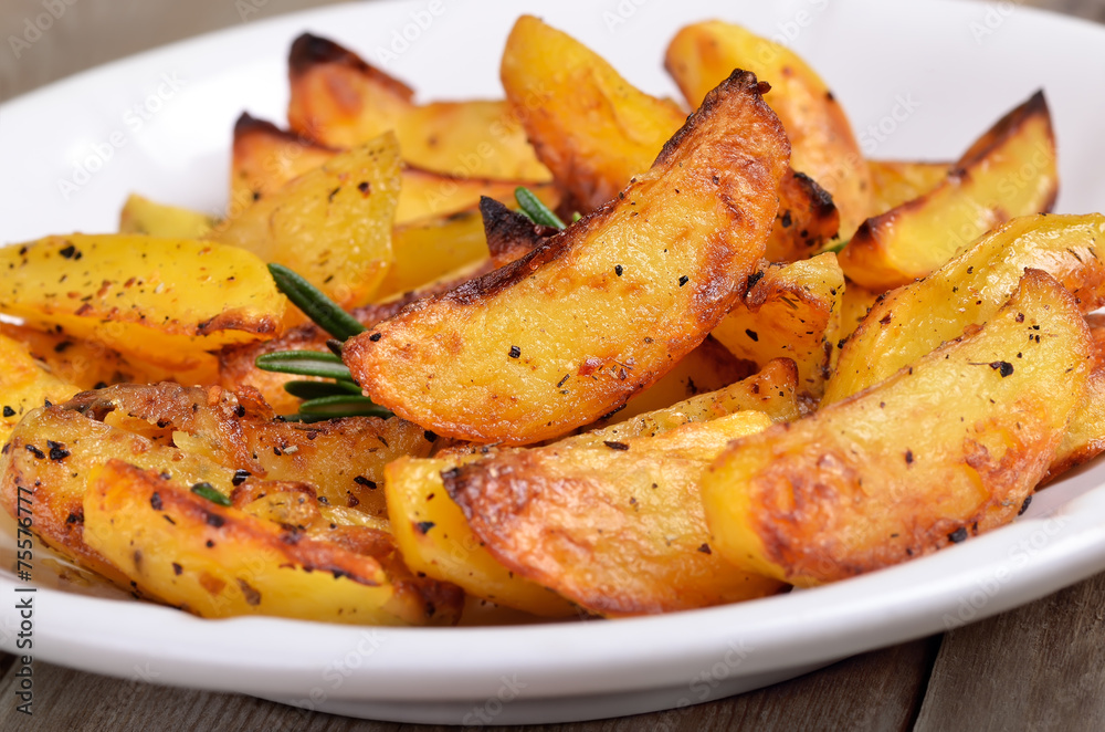 Fried potato wedges on white plate Fried potato wedges on white plate