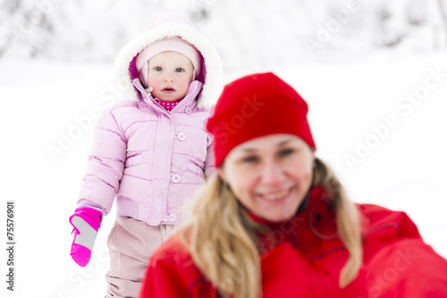 portrait of mother with little daughter in winter