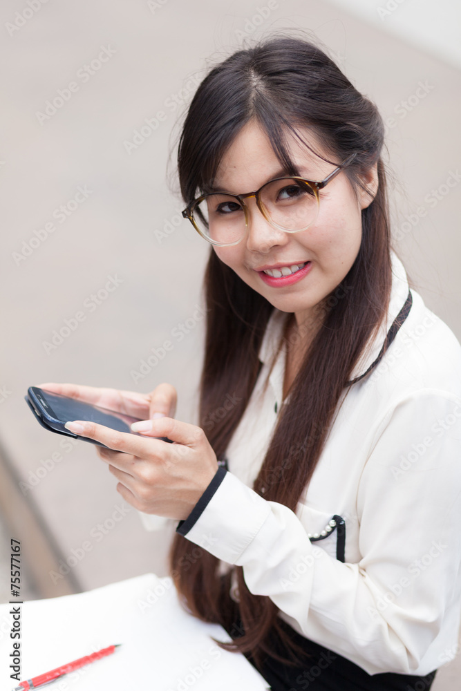 Businesswoman Sitting using a smartphone. Businesswoman Sitting using a smartphone.