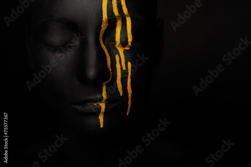 lady in black paint with yellow smudges