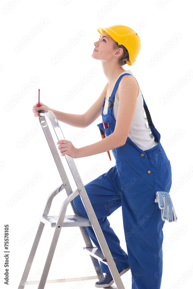 young woman builder in blue coveralls with screwdriver on ladder young woman builder in blue coveralls with screwdriver on ladder