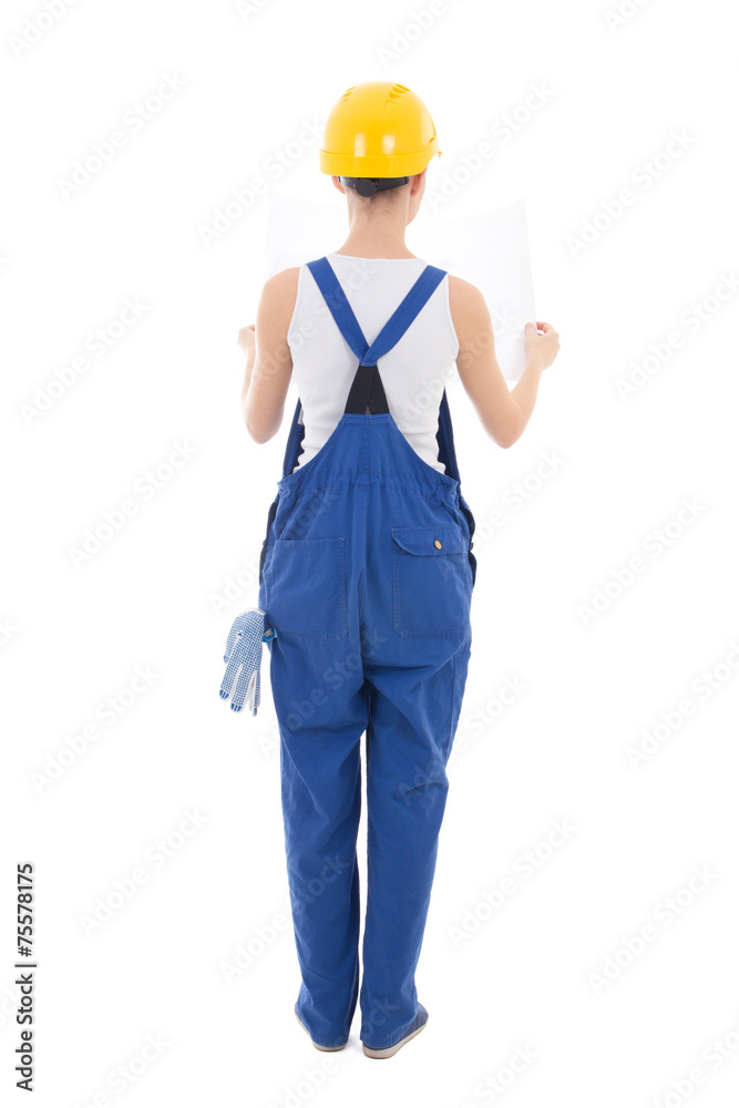 back view of  woman builder in workwear holding building plan is