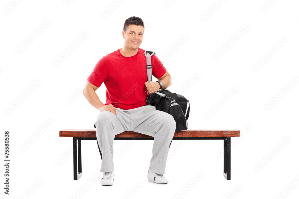 Male sportsman sitting on a wooden bench