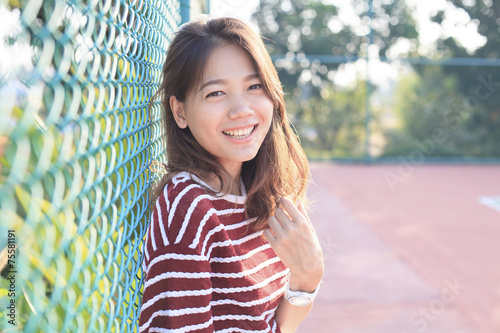 portrait of beautiful young woman toothy smiling with happy face photo