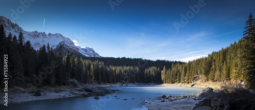 Carezza lake in winter with frosty surface