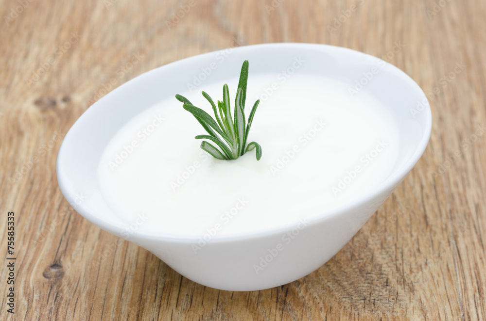 natural yoghurt with a sprig of rosemary natural yoghurt with a sprig of rosemary