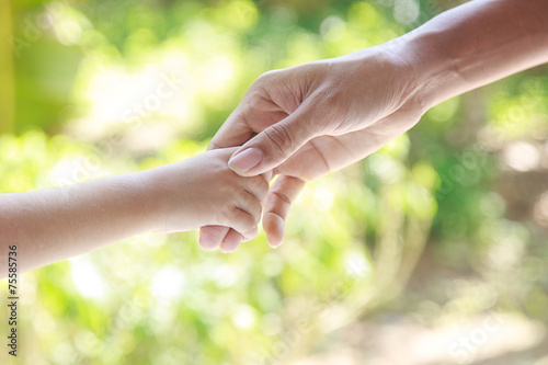 Helping hands  - man holding child hand © banprik