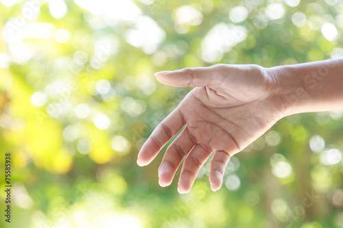 Helping hands against nature background