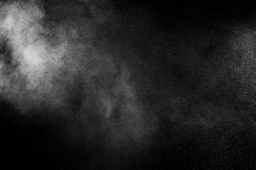 White dust powder particles cloud on black background