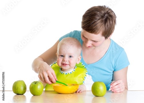 Mom spoon feeding her baby