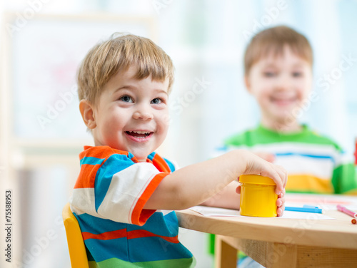 smiling kids painting at home