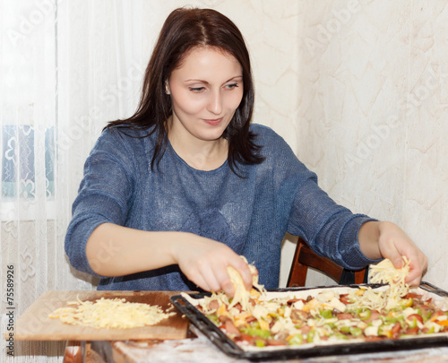 Brunette girl preparing a pizza