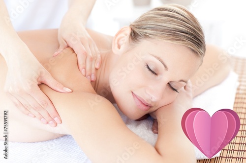 Composite image of beautiful woman receiving a back massage