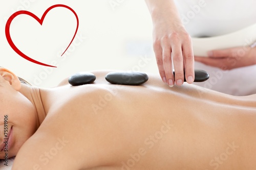 Portrait of a beautiful woman having a massage with stones