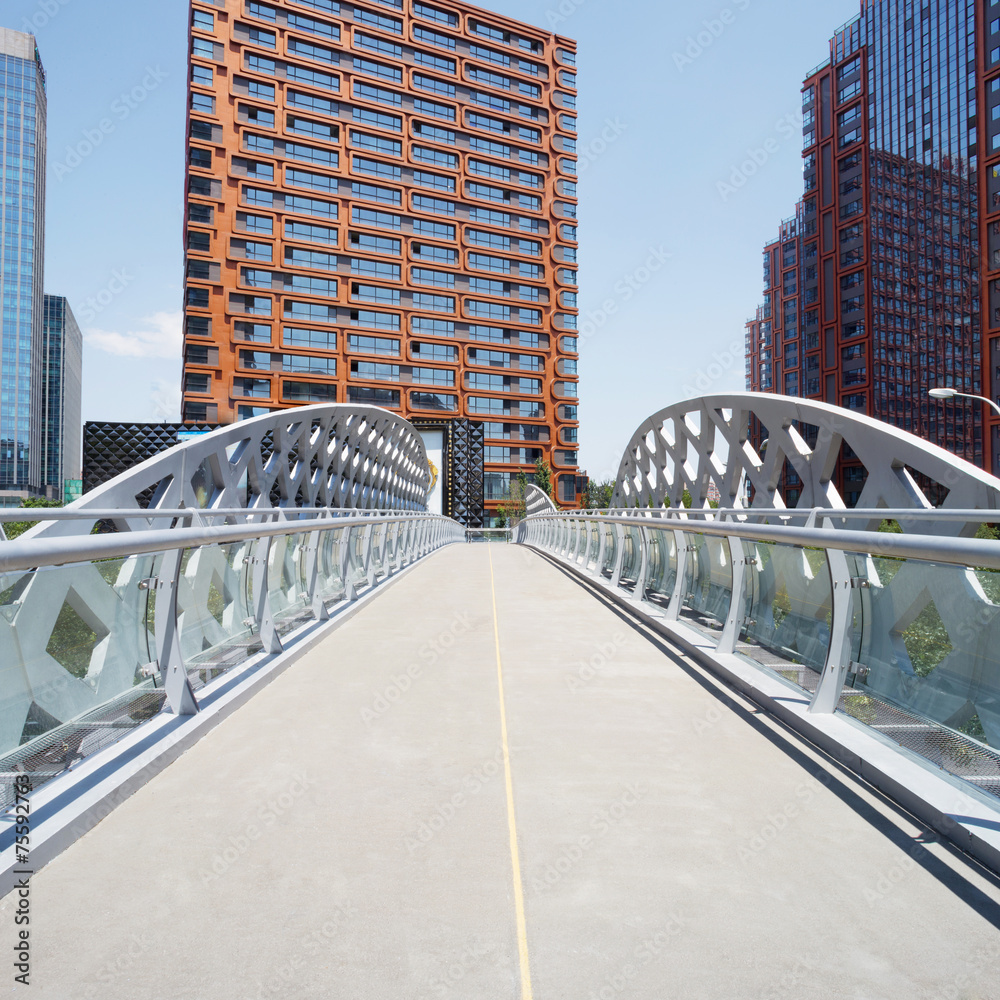 Fototapeta premium footbridge and office building in modern city