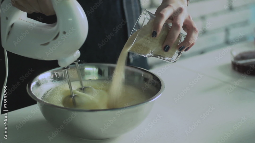 Mixing egg cream in bowl with motor mixer, baking cake Mixing egg cream in bowl with motor mixer, baking cake