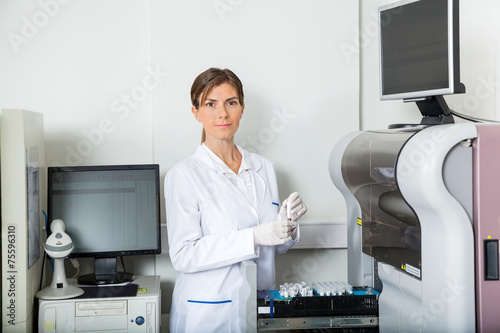 Wallpaper Mural Scientist Loading Coagulation Analyzer With Samples Torontodigital.ca