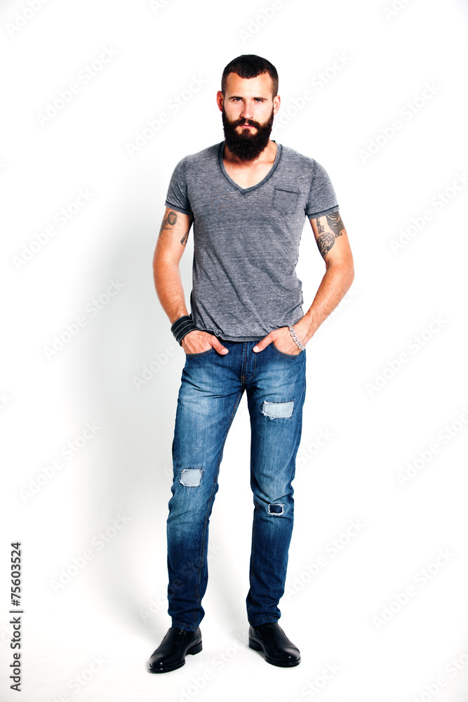 Fototapeta premium Tattooed bearded man wearing gray t-shirt