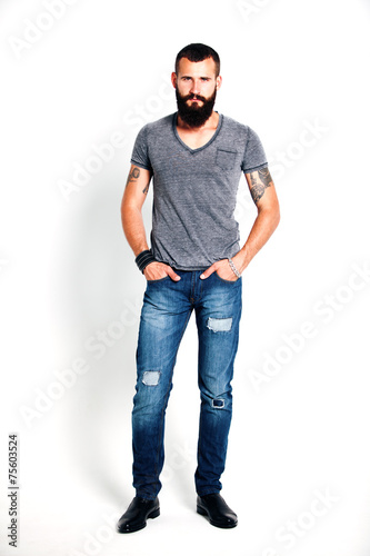 Tattooed bearded man wearing gray t-shirt