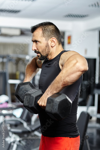 Man doing shoulder workout in a gym