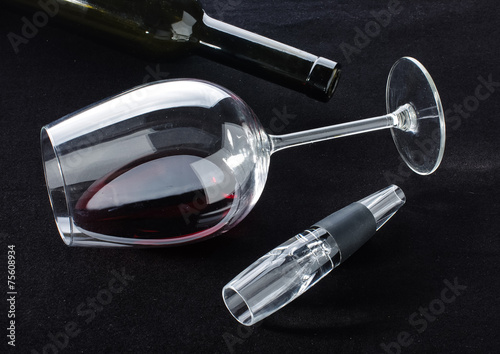 Red wine in the glass and accessories on the dark background photo