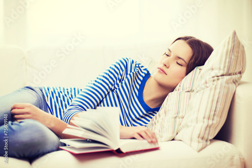 smiling teenage girl sleeping on sofa at home