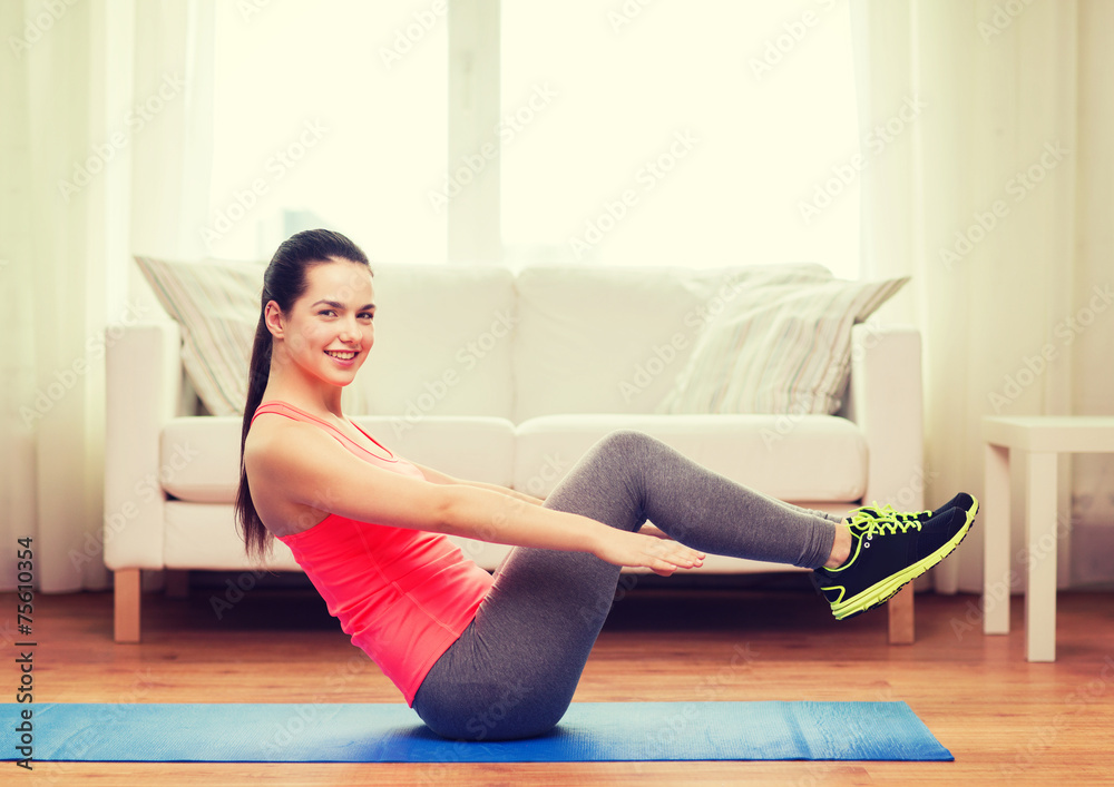 smiling girl doing exercise on floor at home smiling girl doing exercise on floor at home