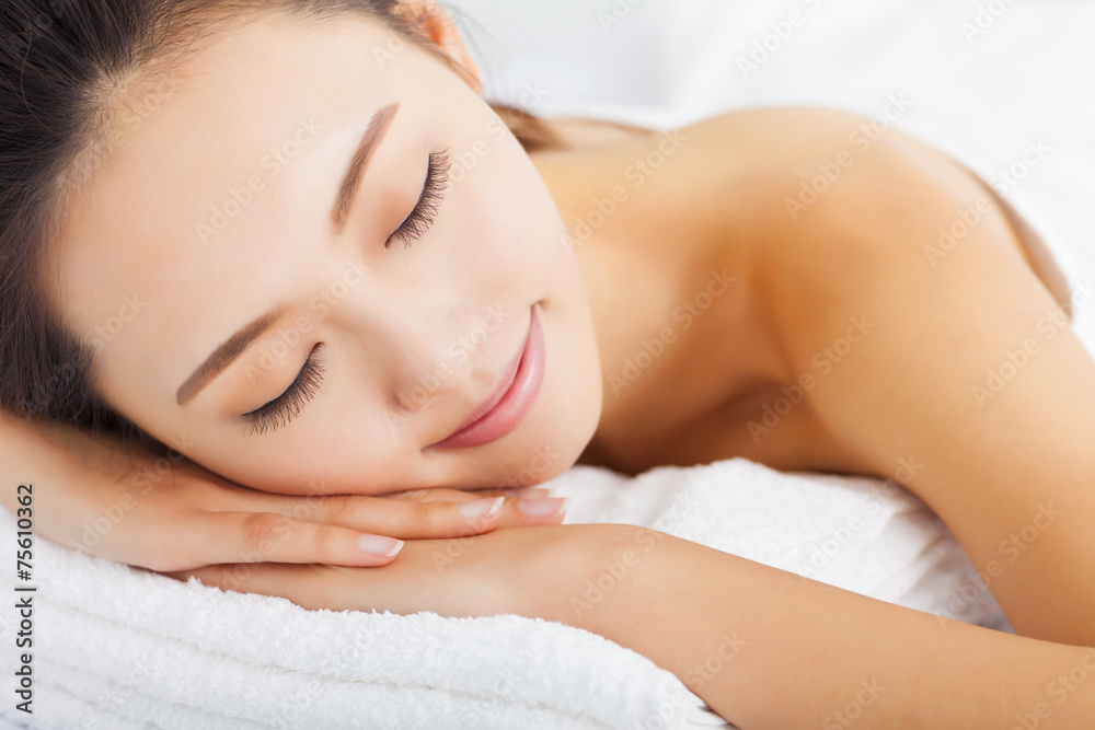 Young woman getting spa treatment over white background Young woman getting spa treatment over white background