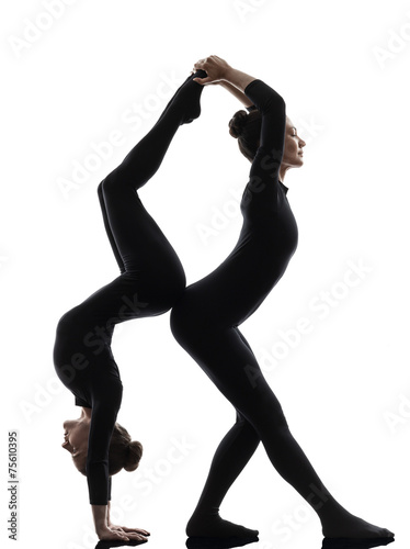 two women contortionist exercising gymnastic yoga silhouette